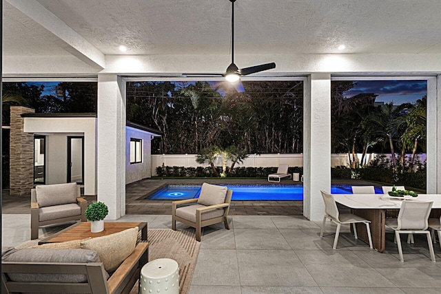 exterior space with a fenced in pool, a patio, ceiling fan, a fenced backyard, and outdoor dining space