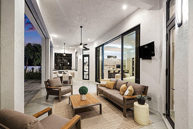 view of patio / terrace with ceiling fan and an outdoor living space