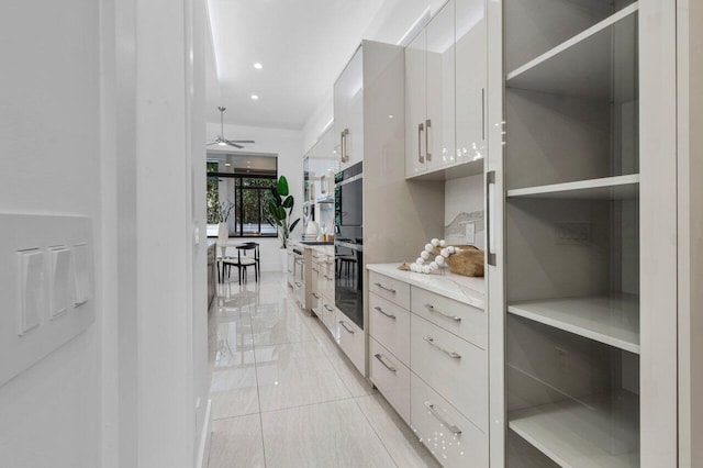 kitchen with white cabinetry, a ceiling fan, light countertops, open shelves, and modern cabinets