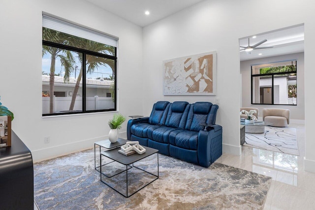 living area featuring baseboards and recessed lighting