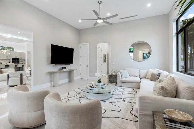 living area with recessed lighting, ceiling fan, and baseboards