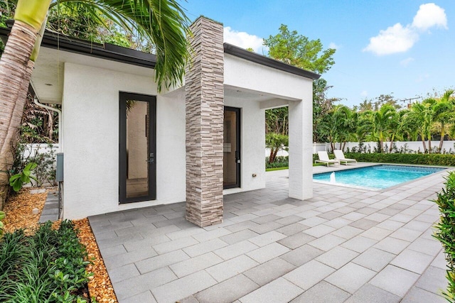 view of pool with a fenced in pool, a patio, and fence