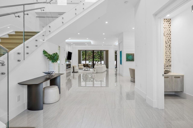 entryway featuring recessed lighting, baseboards, and stairs