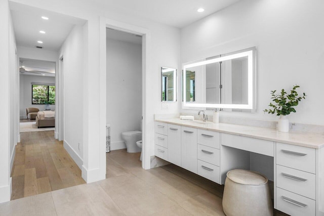 full bath featuring recessed lighting, a bidet, vanity, and toilet