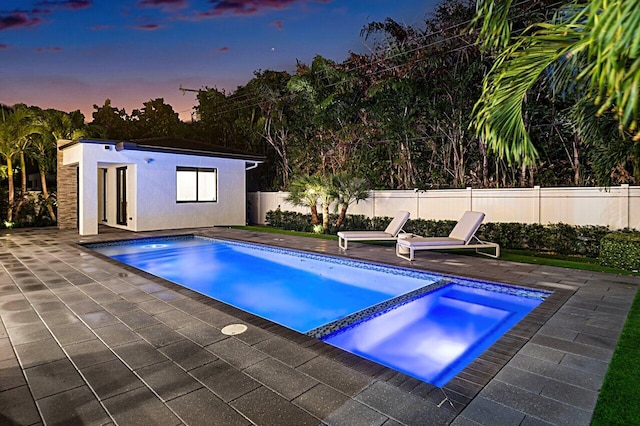 view of pool with a fenced backyard, an outbuilding, an exterior structure, and a patio