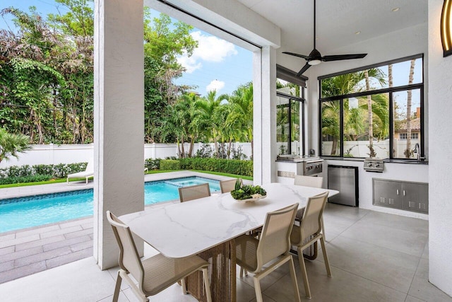 sunroom / solarium featuring a wealth of natural light and a ceiling fan