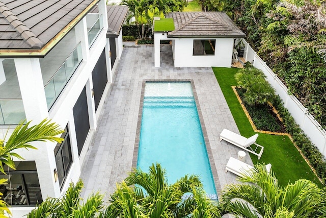 pool featuring a yard, a fenced backyard, and a patio