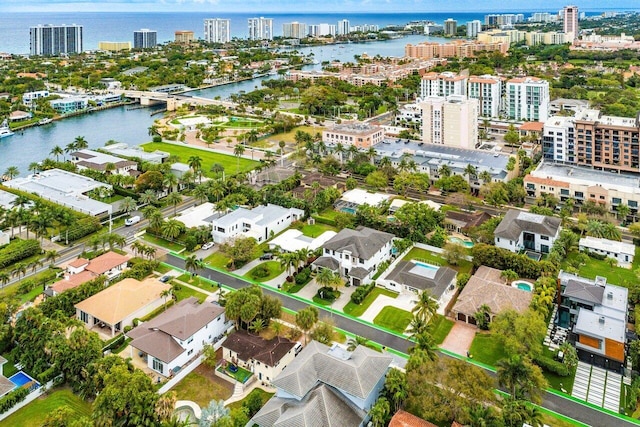 birds eye view of property featuring a water view and a city view