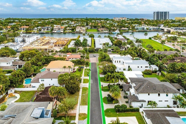 drone / aerial view featuring a residential view and a water view