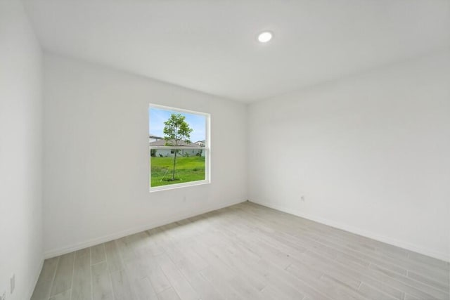 unfurnished room featuring baseboards, recessed lighting, and light wood-style floors