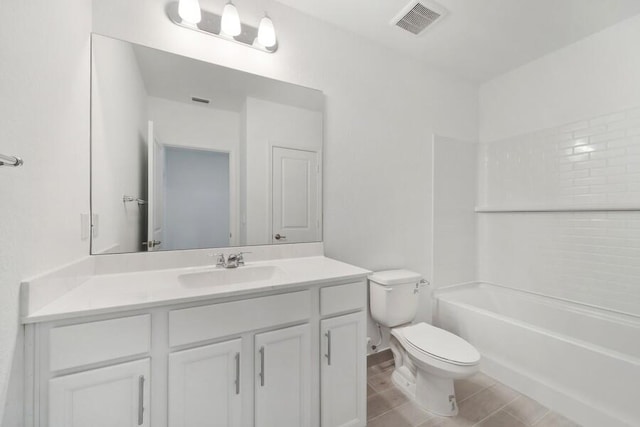 bathroom featuring toilet, washtub / shower combination, visible vents, and vanity