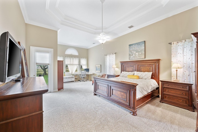 bedroom featuring a tray ceiling, light colored carpet, crown molding, and visible vents