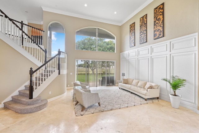 living room with recessed lighting, a towering ceiling, baseboards, stairs, and crown molding