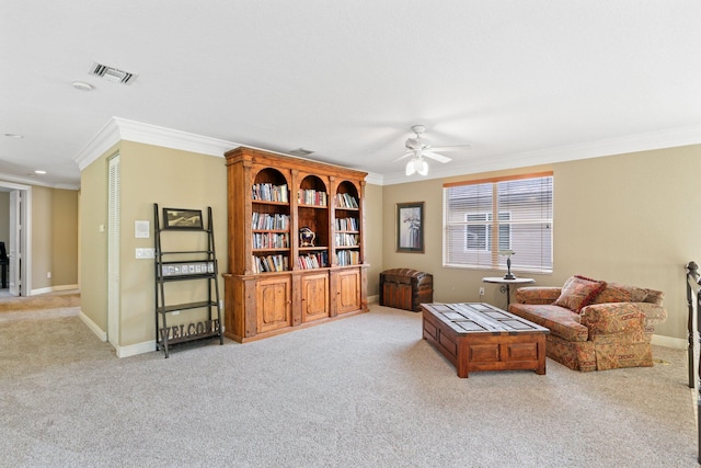 living area with ornamental molding, light carpet, visible vents, and baseboards