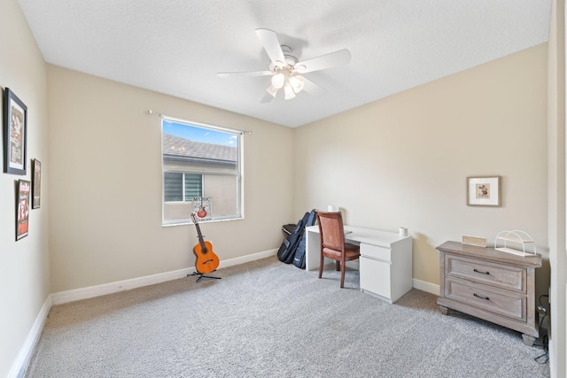 office area with light carpet, ceiling fan, and baseboards