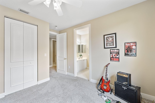 game room featuring baseboards, visible vents, a ceiling fan, and light colored carpet