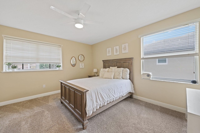 bedroom with light carpet, baseboards, and a ceiling fan