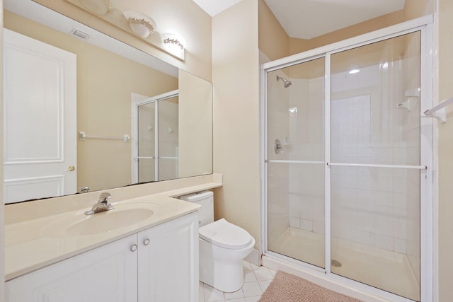 bathroom featuring a shower stall, toilet, and tile patterned floors