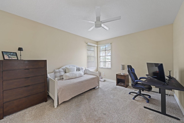 bedroom with light carpet, ceiling fan, a textured ceiling, and baseboards