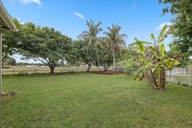 view of yard featuring a rural view and a fenced backyard