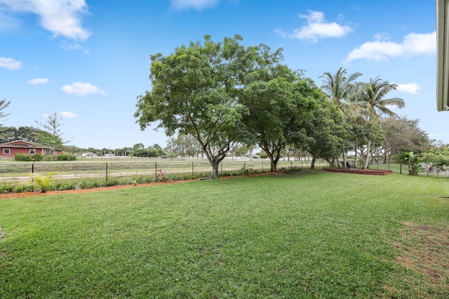 view of yard featuring fence and a rural view