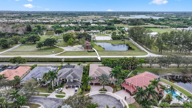 drone / aerial view featuring a water view and a residential view