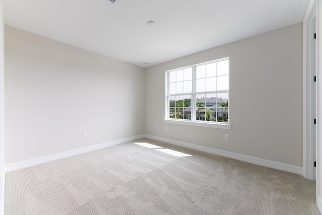 empty room with light carpet and baseboards