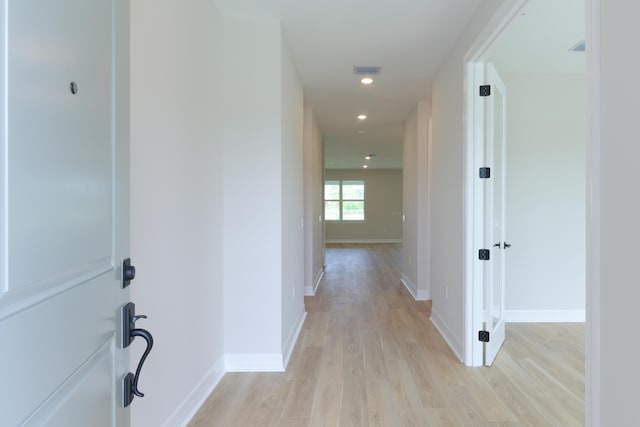 hall featuring recessed lighting, light wood-type flooring, visible vents, and baseboards