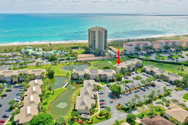 drone / aerial view with a water view, a residential view, and a view of the beach