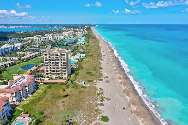 aerial view with a water view and a beach view