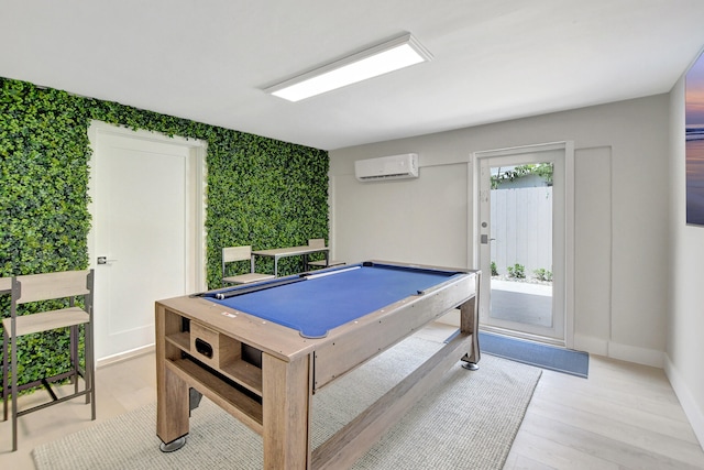 game room with light wood-style flooring, baseboards, an AC wall unit, and pool table