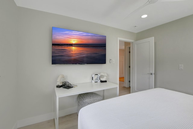 bedroom with recessed lighting, wood finished floors, and baseboards