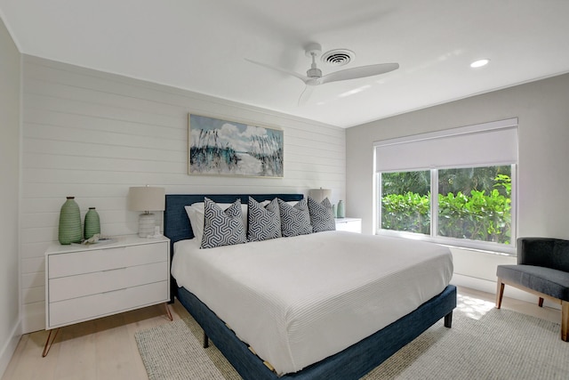 bedroom with light wood-type flooring, visible vents, and a ceiling fan