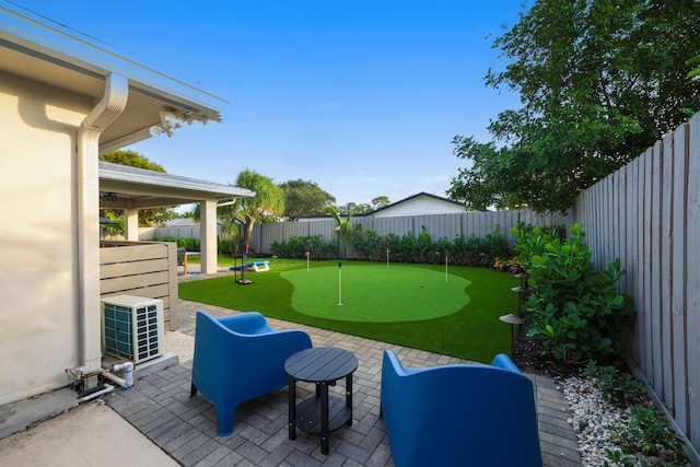 view of yard with central AC, a patio area, and a fenced backyard