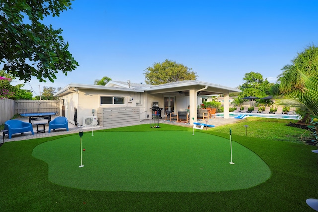 back of property with a fenced in pool, ac unit, french doors, a patio, and a fenced backyard