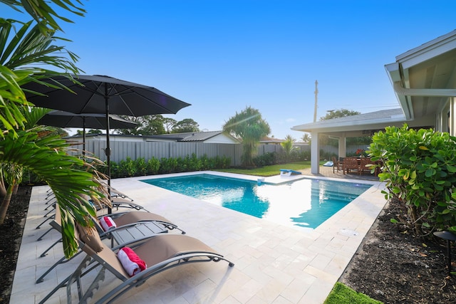 view of swimming pool featuring a patio area, a fenced backyard, and a fenced in pool