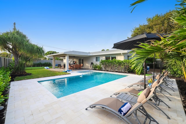 view of swimming pool featuring a fenced backyard, a fenced in pool, a lawn, and a patio