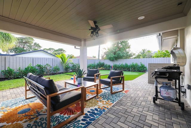 view of patio / terrace featuring ceiling fan, an outdoor living space, and a fenced backyard