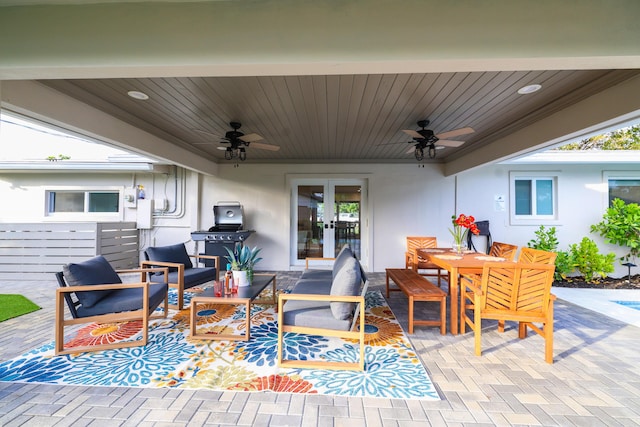 view of patio / terrace with outdoor dining space, ceiling fan, an outdoor hangout area, and french doors