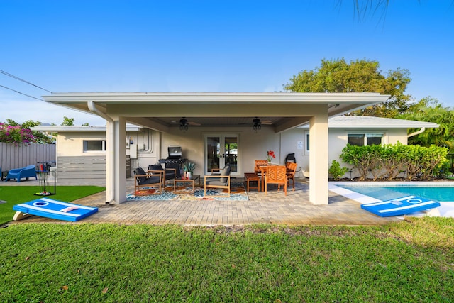 rear view of house featuring a patio, a yard, stucco siding, ceiling fan, and fence