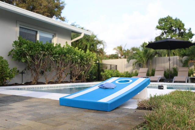 view of swimming pool with a patio, fence, and a fenced in pool