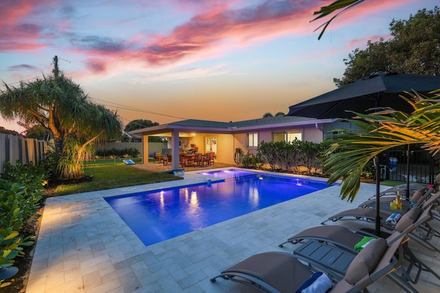 view of swimming pool with a patio, a yard, a fenced backyard, and a fenced in pool