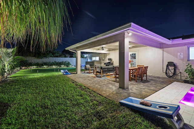 view of patio featuring outdoor lounge area, fence, and ceiling fan