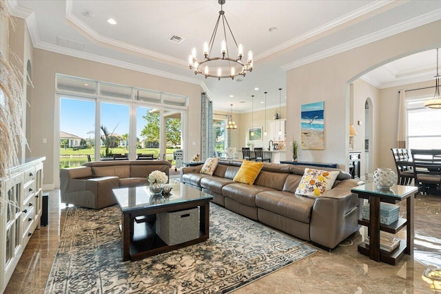 living room with crown molding, arched walkways, visible vents, and a notable chandelier