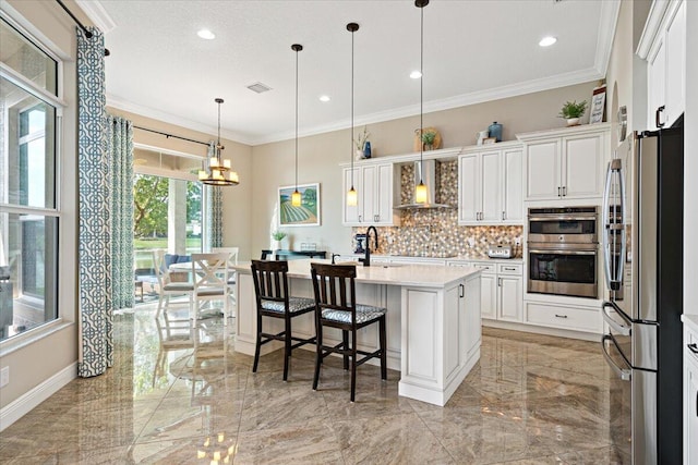 kitchen with marble finish floor, stainless steel appliances, wall chimney range hood, and crown molding