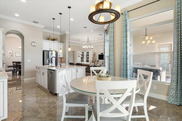 dining area with arched walkways, marble finish floor, visible vents, and baseboards