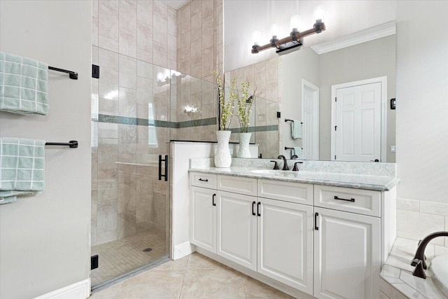 bathroom with tile patterned floors, a shower stall, ornamental molding, and vanity