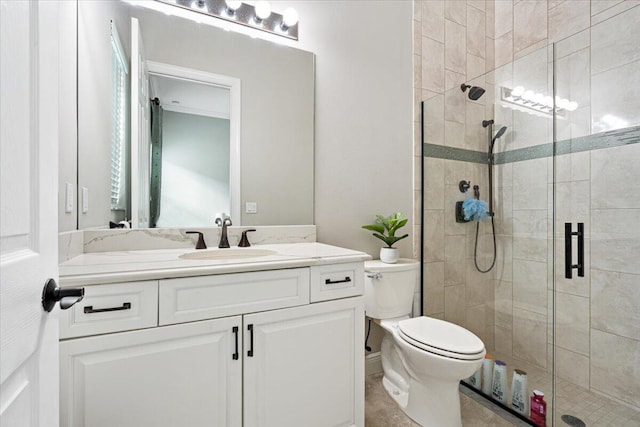 full bathroom with toilet, a shower stall, and vanity