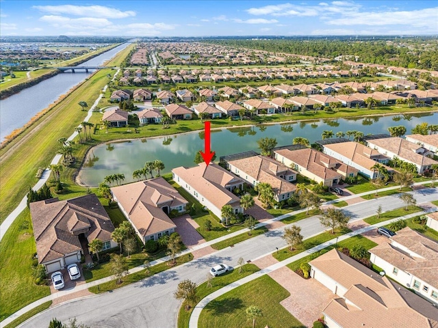 bird's eye view with a water view and a residential view