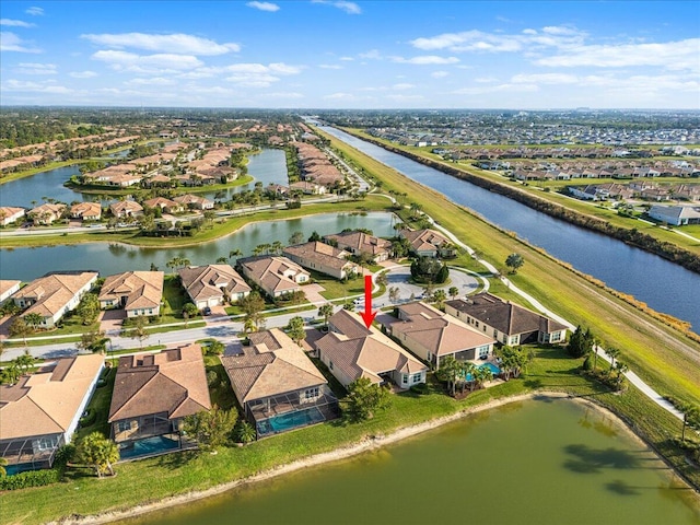 birds eye view of property with a water view and a residential view